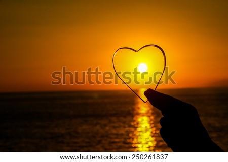 Love Concept Heart and Sun Setting on the Atlantic Ocean
