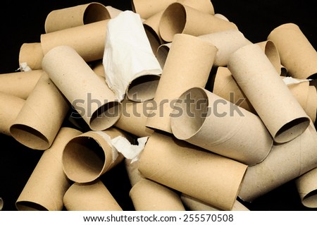 Empty Toilet Rolls Stack Up On a Black Background