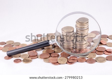 Picture of a Business Money Concept Idea Coins and Loupe Magnify Glass