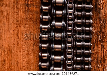 Part of a Used Automotive Gear Chain n a Wooden Background