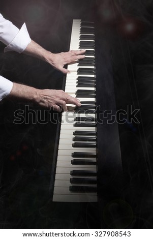 pianist on smokey stage playing an electric piano keyboard