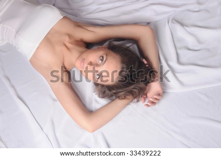 Close-up of beautiful happy woman on the bed.