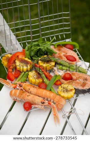 Norwegian salmon steaks, lobsters and vegetables for barbecue