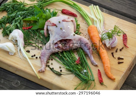 Fresh quail with garlic, carrots, green peppers and herbs to fragrant broth