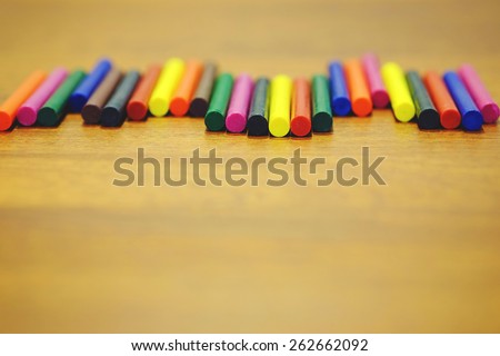 Colorful wax crayons on wooden background