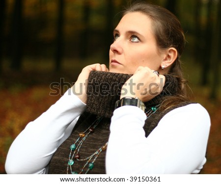Attractive pretty woman portrait in autumn. In the USA it is called The Fall. This cute female outdoor photo was made in the forest