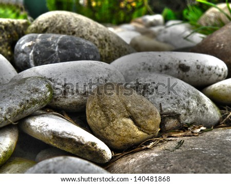Closeup macro detail of little stones in garden. HDR colorful nature background in summer time. Decoration.
