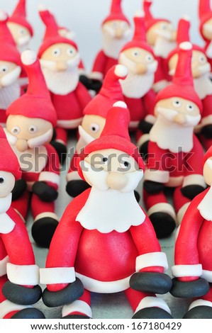 Santa Clause made of fondant sitting together