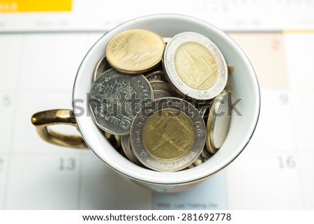 glass jar for tips with money isolated on white. Thailand coins