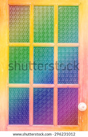 soft focus of Old wooden doors decorated with colored glass. Add finishing touches by putting filters in various colors beautifully.
