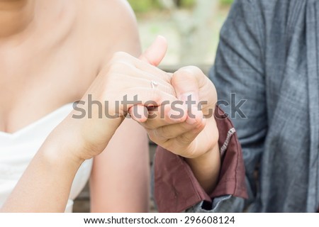 soft focus of The groom wears a wedding ring on the bride\'s hands. The most important of them.