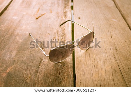 soft focus of Sunglasses resting on wood. Color, view vintage style of old. Very beautiful composition
