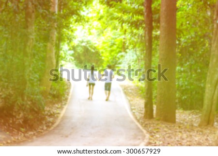 blurred photo of Man and woman walking hand in hand, walk the path that they both dreamed planned.And walk along the way to reach the intended destination. vintage color tone add color to a beautiful.