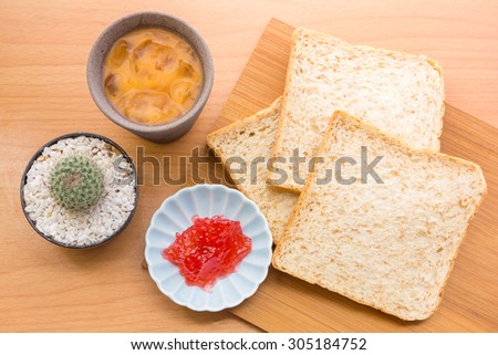 Bread with jam, strawberry tasty dishes on a wood floor. Ready to eat in the morning The appetizers are not hungry