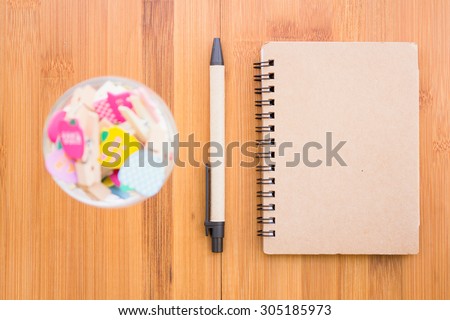 Vintage style of open notebook and pen on the old wooden floor.