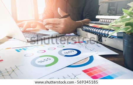 soft focus of businessman hand working laptop on wooden desk in office in morning light. vintage effect