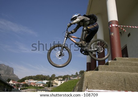 Mountain biker jumping off stairs