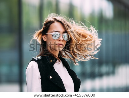 Street fashion concept. Young beautiful model in the city. Beautiful blonde woman wearing sunglasses close-up portrait of a young sexy girl hipster