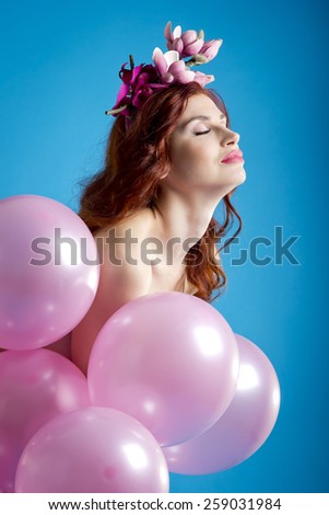 Red-haired girl with pink balloons