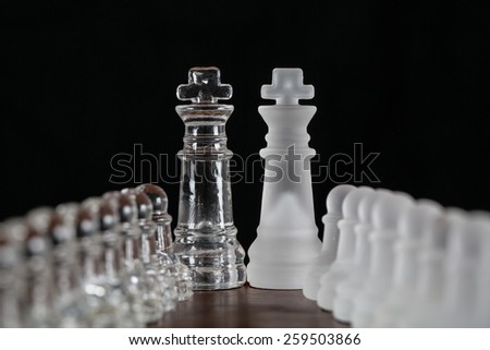 Glass chess pieces leading to the kings.