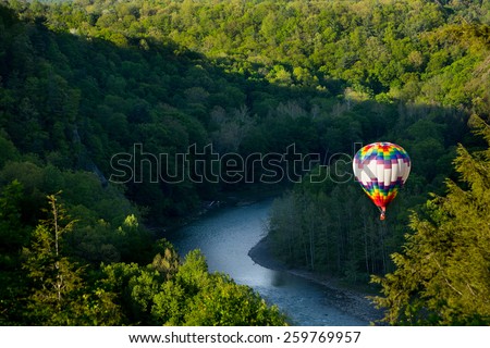 Hot air balloon over the gorge at Letchworth State park on a sunny summer day.