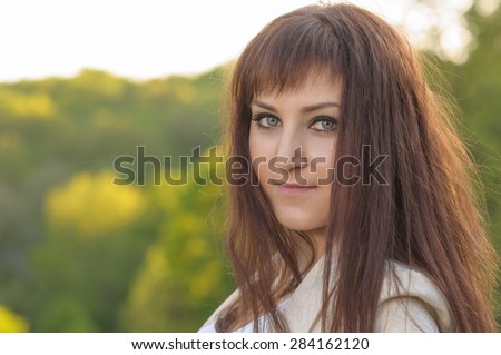 Portrait of a smiling woman in green background