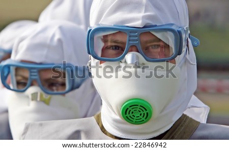 The group of people Man in the insulating suit in a protective mask