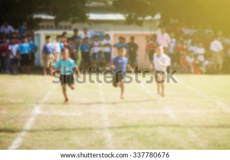 Blurred photo of Thai kids running in school