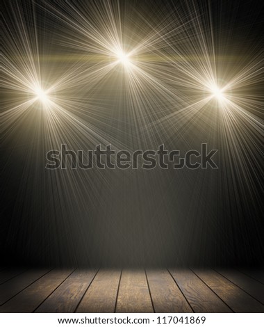 Spot lighting over dark background and wood floor. concert