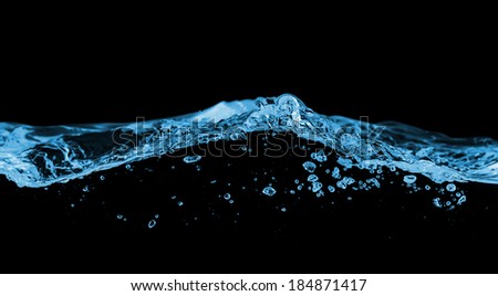 Blue water wave with bubbles in the sea on a black background for text.