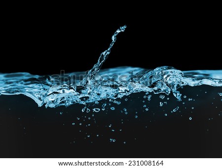 Blue water wave with bubbles in the sea on a black background for text.