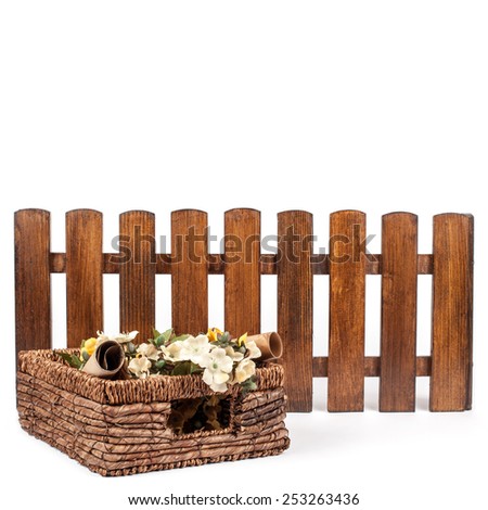 decor basket with flowers and fence on a white background