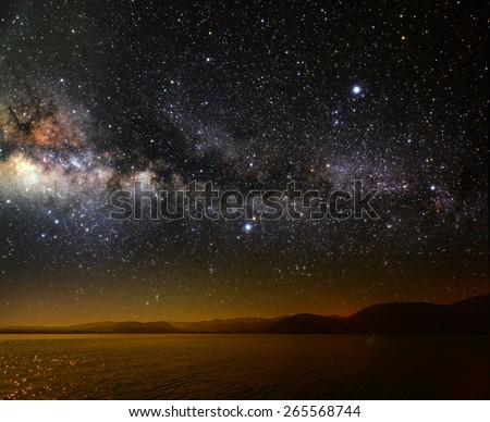 month on a background star sky reflected in the sea. Elements of this image furnished by NASA