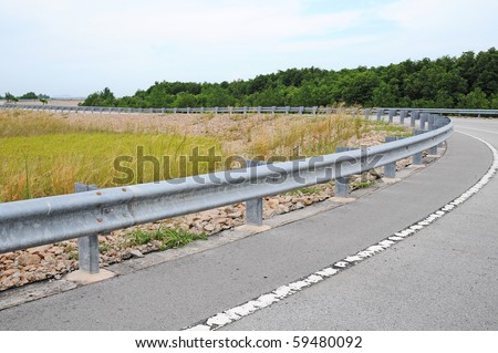 Highway Passing Through The Countryside With Crash Barrier