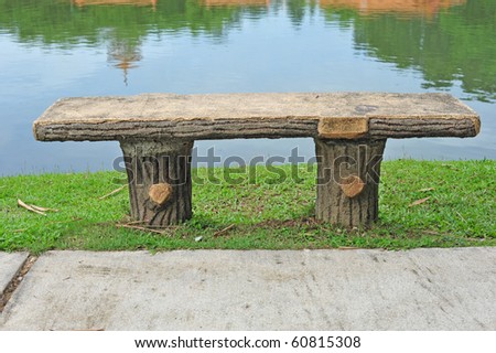 A Solitary Stone Bench Near A Pond