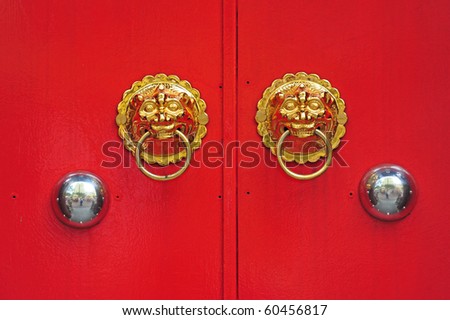 Lion Head Brass Door Handle On A Red Painted Door