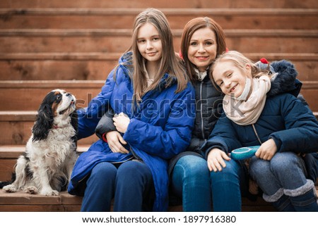 Family with dog. Mother with daughters. People with little dog.