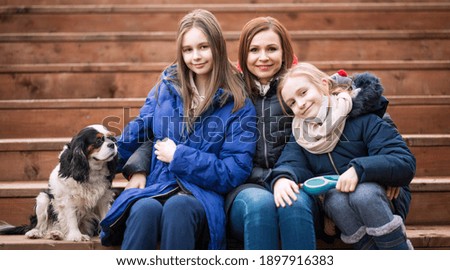 Family with dog. Mother with daughters. People with little dog.