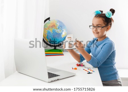 Little scientist working on new project, little girl studying robotics on laptop online