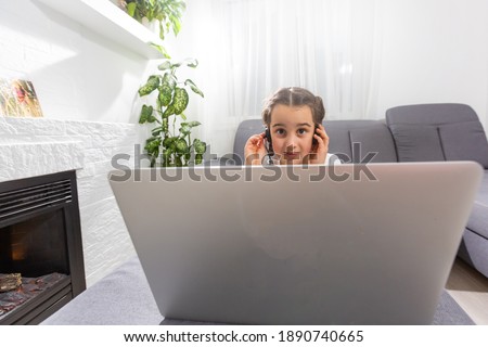 A young girl is attending online school or classes. Study in lock down as Schools closed due to Covid-19. technology during lockdown. Learning at home concept