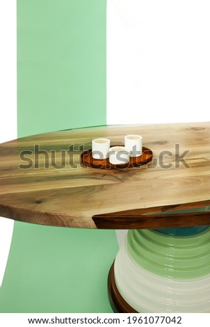 Luxurious wooden table with full hardwood and epoxy resin on a white background with a green ribbon.