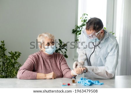 In modern private clinic doctor is listening heart of senior patient sitting on hospital bed. Healthcare medical medicine consultation, using stethoscope giving professional treatment to sick ill