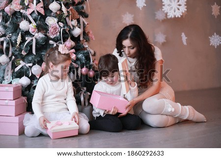 A young family with children decorates the house for the holiday. New Years Eve. Waiting for new year.