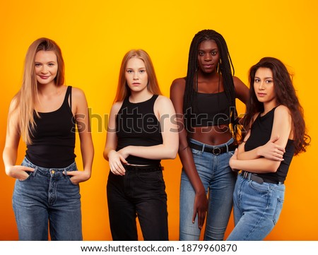 diverse multi nation girls group, teenage friends company cheerful having fun, happy smiling, cute posing on yellow background, lifestyle people concept, african-american, asian and caucasian