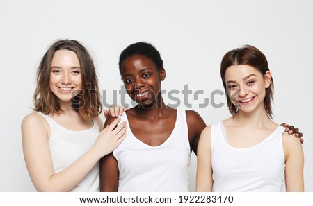 lifestyle, friendship and people concept - group of three girls friends of different nationalities