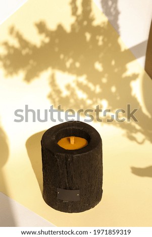 Wooden candle holder rustic interior centerpiece with candles in a cozy barn setting.
