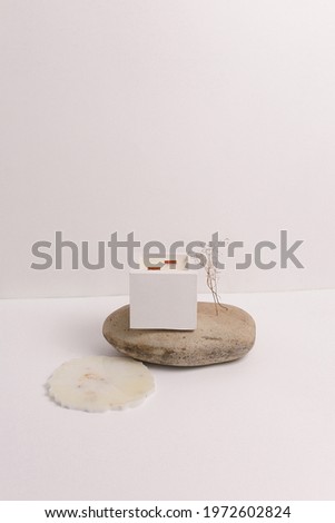 scented candles on off white background in rock holder