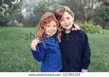 Happy siblings with arms around each other