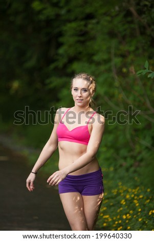 Fitness woman posing on a running trail