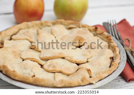 Homemade apple pie with overlapping heart shaped crust.